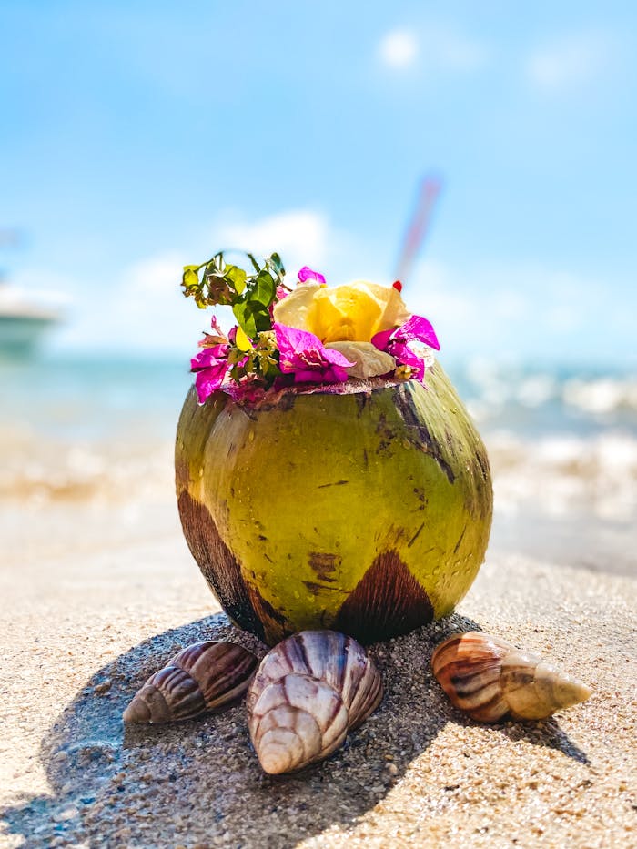why-choose-us-01 Vibrant coconut drink with flowers on sandy beach in Mauritius, ideal for tropical themes.